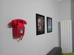 a red phone is hanging on a wall at Villa Nonno Nicola in Montenero di Bisaccia
