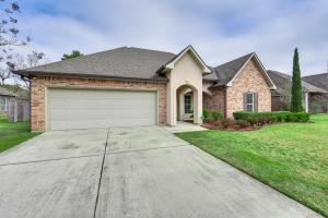 a house with a garage in a yard at Spacious Zachary Home 12 Mi to Baton Rouge! in Zachary