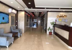 a hallway of a hospital with chairs and a lobby at اجنحة كنوز in Jeddah