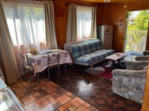 a living room with a table and a couch at apartment with sea view in Ancud +5 photos