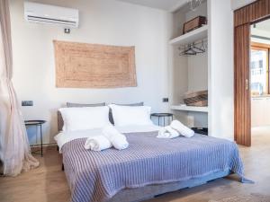 a bedroom with a bed with towels on it at Seaview Apartment - Poros Relaxing Beachfront Flat in Poros