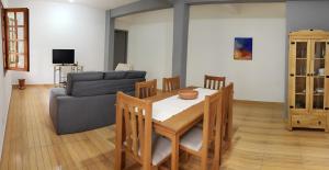 a living room with a table and a couch at Casa do Lago in Cunha