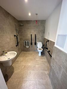 a bathroom with a toilet and a sink at Lakeview Holidays in Whelford