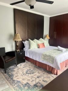 1 dormitorio con 1 cama grande y 1 silla en Silken Trap Accommodation NO LOADSHEDDING en Johannesburgo