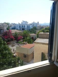 una finestra con vista sulla città di Hotel Avra a Città di Egina