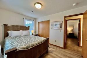 a bedroom with a wooden bed with a wooden floor at Charming remodeled 2 bed GEM Middletown in Middletown