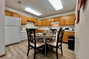 a kitchen with a table and chairs and a white refrigerator at Charming remodeled 2 bed GEM Middletown in Middletown