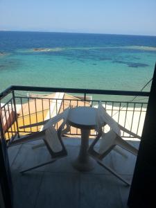 a view of the beach from the balcony of a boat at Hotel Avra in Egina