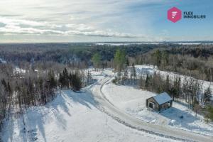 an aerial view of a cabin in the snow at The Green Chill at Cité-Jardin - Private SPA, Ping pong, Fireplace & Pool in Saint-Basile