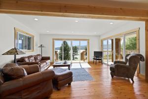 a living room with a couch and a chair at Lakefront Gem with Hot tub and Views in Sandpoint