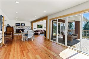 a living room with a table and chairs and a living room at Lakefront Gem with Hot tub and Views in Sandpoint