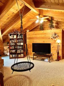 a living room with a swing in a cabin at LUXURIOUS TN Mtn Lodge- Sleeps 22+, Hiking & Lake in Butler