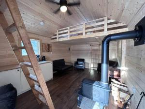 a room with a stove in a wooden cabin at Eagle Cabin in Golden