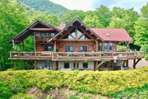 a large wooden house with a large deck at LUXURIOUS TN Mtn Lodge- Sleeps 22+, Hiking & Lake in Butler