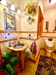 a bathroom with a sink and a toilet at LUXURIOUS TN Mtn Lodge- Sleeps 22+, Hiking & Lake in Butler