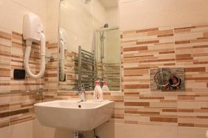 a bathroom with a sink and a mirror at La Fiera GuestHouse in Fiumicino