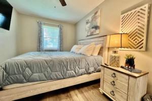 a bedroom with a bed with a dresser and a window at Remodeled 2 BDRM Ranch Attached Home Liberty, TWP in Rockdale