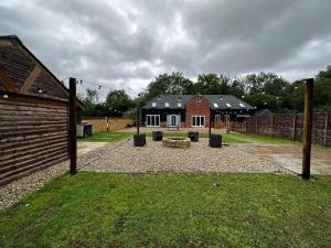 a backyard with a fire pit in front of a house at Lakeview Holidays in Whelford