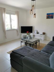 a living room with a couch and a table at Grand appartement a 300M de la plage in Sainte-Maxime