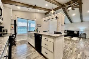 a large kitchen with white cabinets and a large window at Amazing riverside New Construction home in Middletown in Middletown