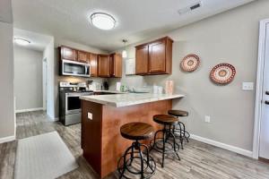 a kitchen with a counter and stools in it at Brand New Home Walking distance to Spooky Nook in Hamilton