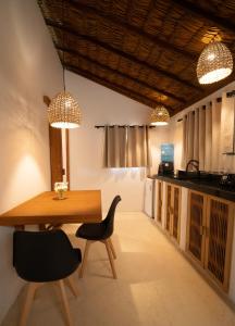 a dining room with a table and chairs and lights at ALTO MAR by Alto Atins in Atins