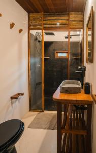 a bathroom with a table with a glass shower at ALTO MAR by Alto Atins in Atins