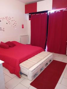 a bedroom with a red bed and red curtains at Dalla Rossa in Montelupo Fiorentino