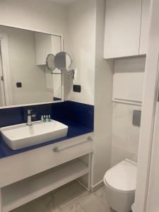 a bathroom with a sink and a toilet at Orbi city Twin Towers in Batumi