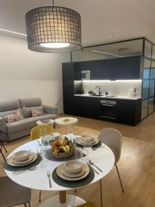 a living room with a table with a bowl of fruit at Soho Moraleja I in Alcobendas +6 photos