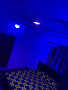 a blue room with a bed with a blue ceiling at Classic suites chillout 