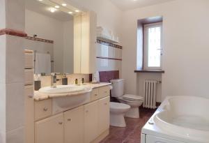 a bathroom with a sink and a toilet and a mirror at La Terrazza del Barbaresco in Barbaresco +22 photos