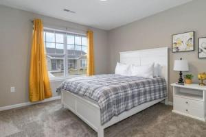 a bedroom with a large bed and a window at BRAND NEW Home away from Home among the Nook in Hamilton