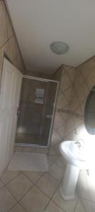 a bathroom with a shower and a toilet at Cavilla Lodge in Vereeniging