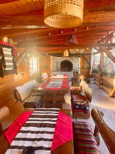 a large room with several tables and a fireplace at Casa Carmen in Dorna Arini