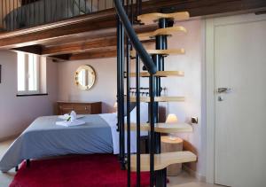 a spiral staircase in a bedroom with a bed at La Terrazza del Barbaresco in Barbaresco