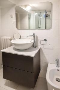 a white bathroom with a sink and a mirror at O01 - Osimo, trilocale ristrutturato in centro storico in Osimo