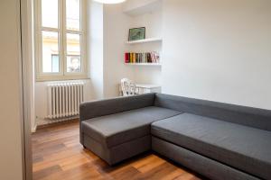 a couch in a living room with a window at O01 - Osimo, trilocale ristrutturato in centro storico in Osimo