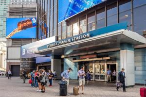 un groupe de personnes debout à l'extérieur d'un bâtiment dans l'établissement 40 OFF 3Days, 9 min to EWR, 2 Queen Beds, Sleeps 6, à Newark