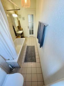 een badkamer met een bad, een toilet en een wastafel bij Cozy Central 1BD Fast WiFi in Bern