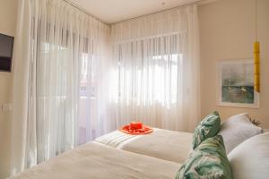 a bedroom with a bed and a large window at Samos Tropic Apartments in Ríva