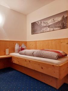 a bedroom with a wooden bed in a room at Haus Gstrein in Oetz