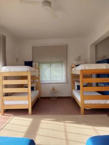 a room with three bunk beds and a window at Villa Nova Nautic & Nature in Eira do Chão
