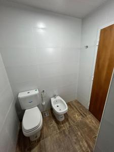 a small bathroom with a toilet and a bidet at Plaza Km 325 in San Lorenzo