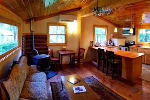 a living room and kitchen with a couch and a table at Farmview Cottage at White Lotus Eco Spa Retreat in Stanardsville