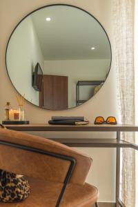 a mirror above a desk in a living room at Samos Tropic Apartments in Ríva