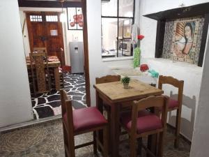 a dining room with a table and two chairs at La cabaña del TIO PEPE in Taxco de Alarcón