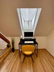 an attic office with a desk and a window at U Lupka - Ostrava in Ostrava