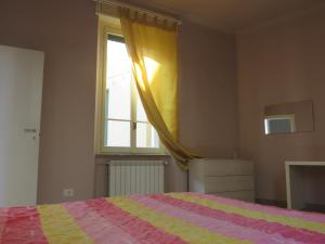 a bedroom with a bed and a window at Casa Luna tra Como e Milano in Saronno
