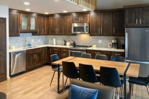 a kitchen with wooden cabinets and a table and chairs at Yampa View 307 in Steamboat Springs